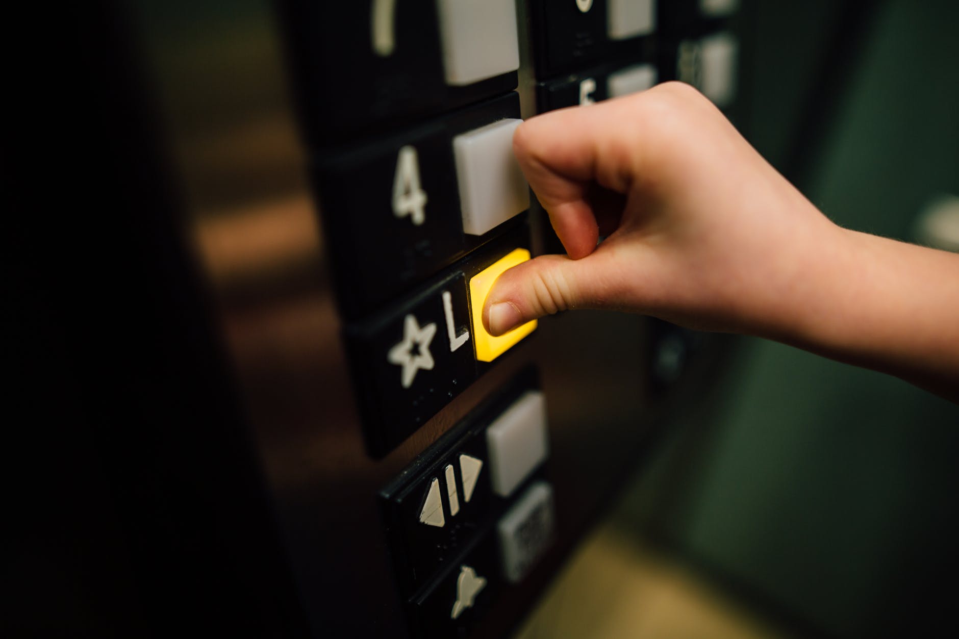 anonymous person pressing button of lift