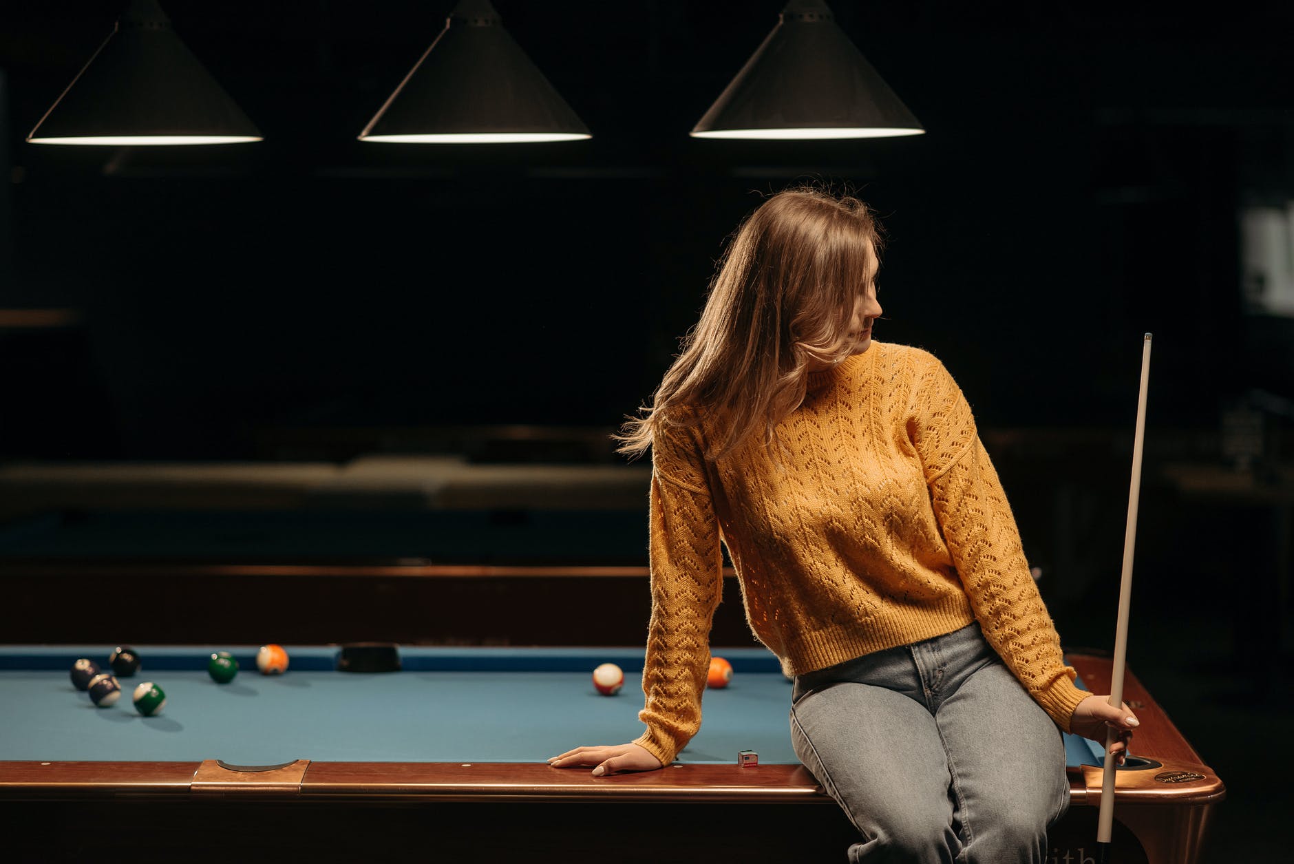 a woman on a billiard table